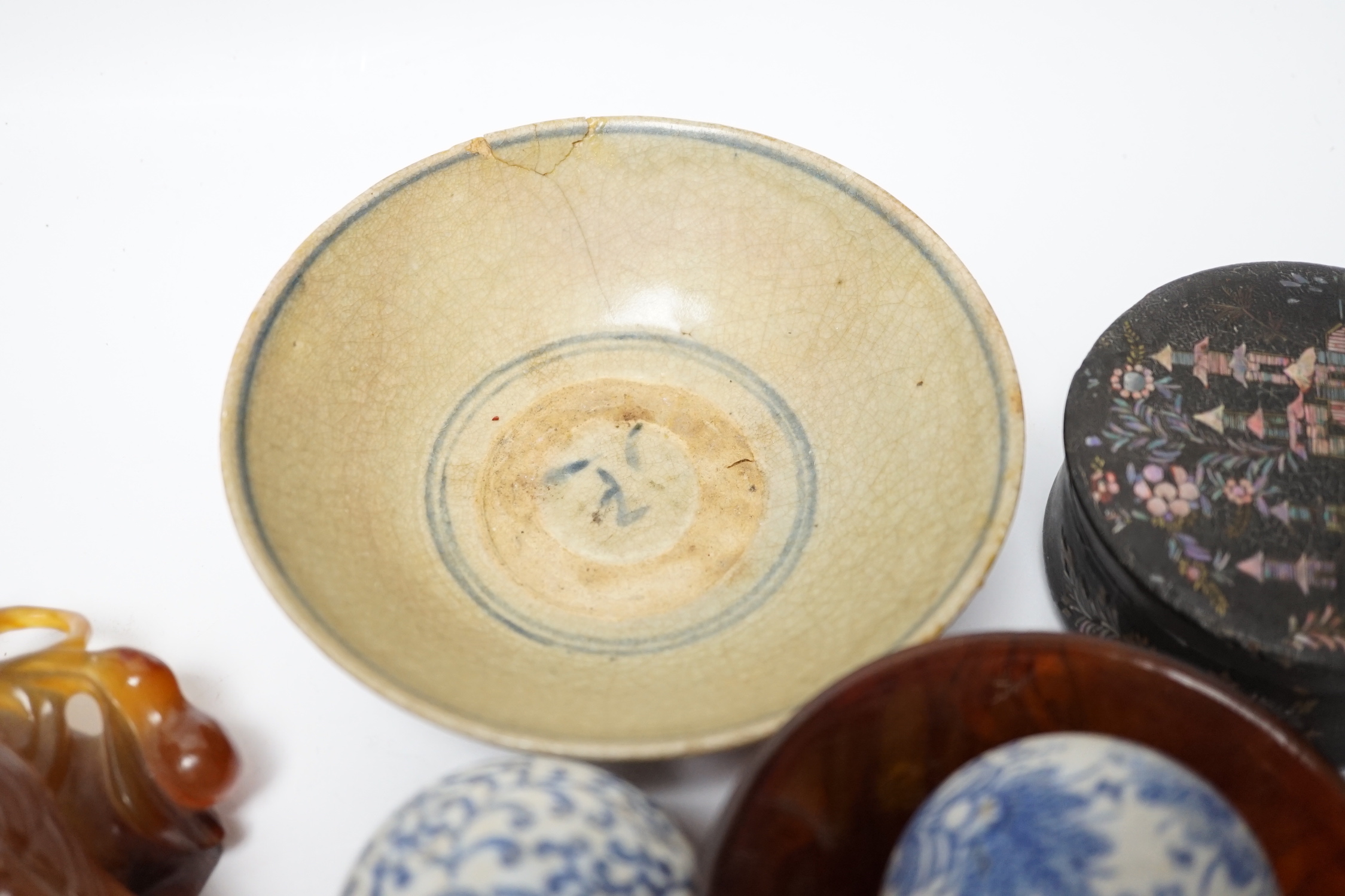 Eleven Chinese or Japanese items including; a bowl, a red lacquer box, an agate carving of a bird group, a carved hardstone lion tortoise, mother of pearl counters, etc.